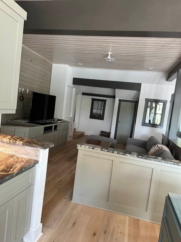 Kitchen with dark countertop and sage cabinetry — 2