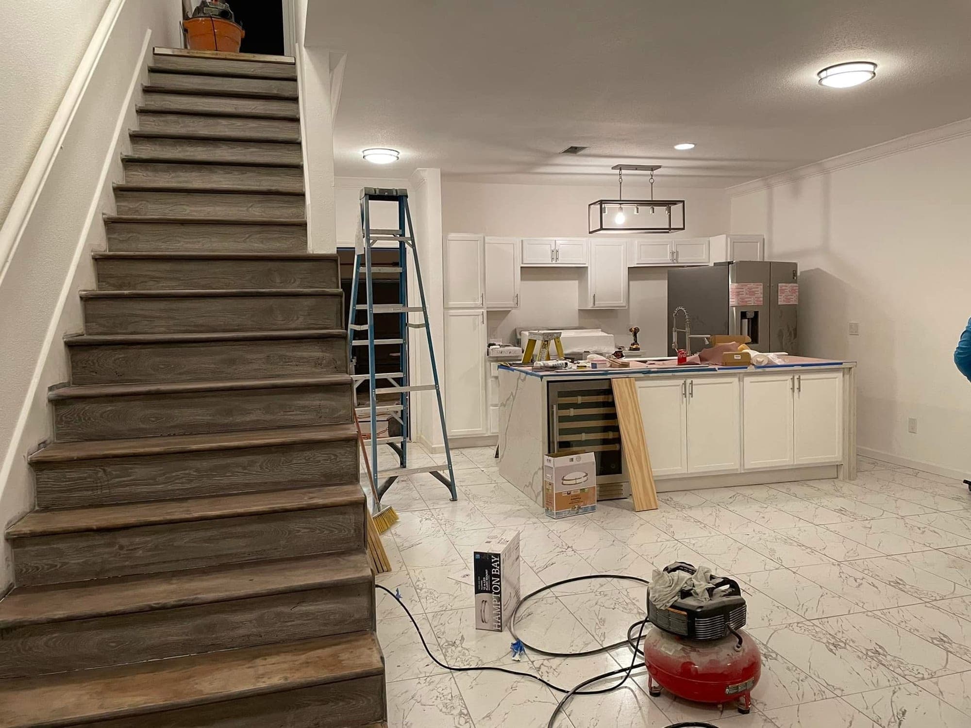 Marble-look flooring from the staircase to the kitchen